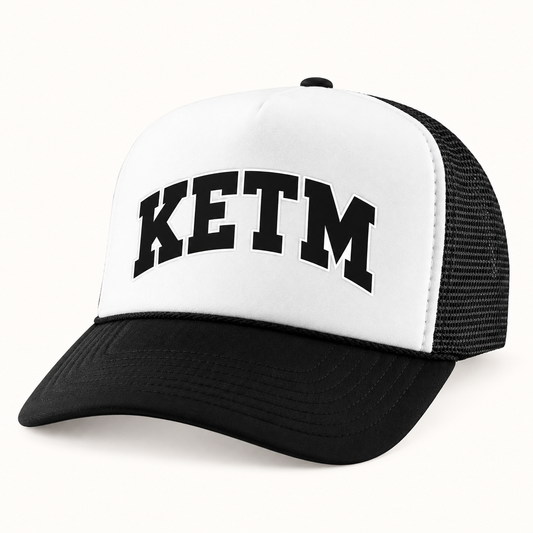 KETM foam-front trucker hat in Black White, arched DTF logo mockup