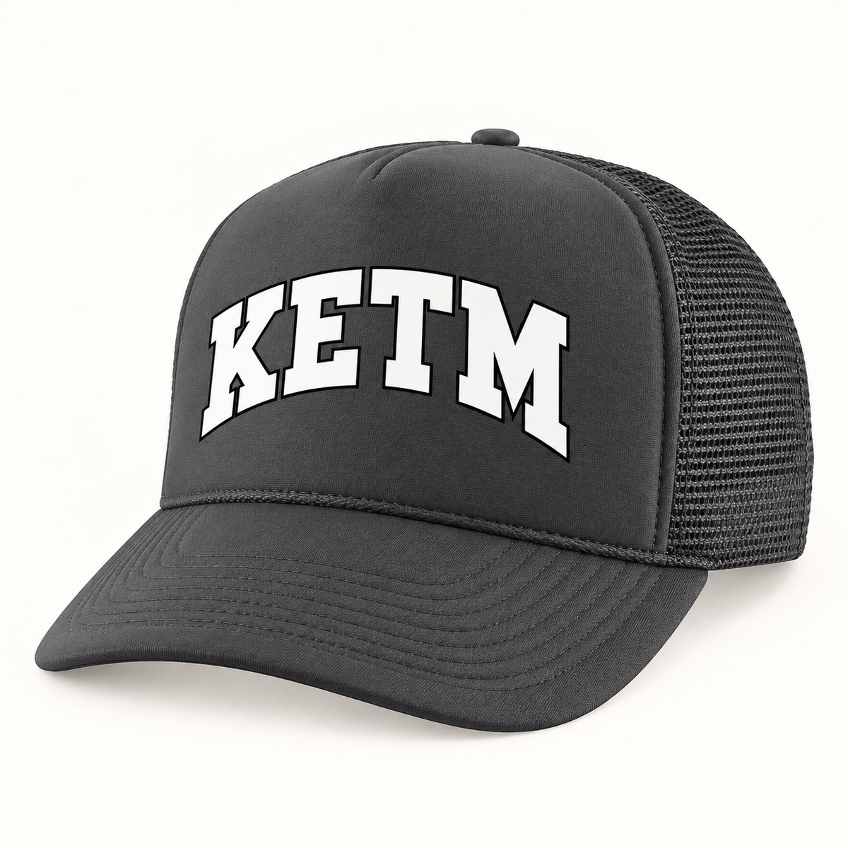 KETM foam-front trucker hat in Charcoal, arched DTF logo mockup, approximate color