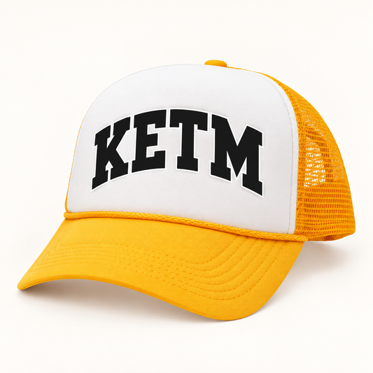KETM foam-front trucker hat in Gold White, arched DTF logo mockup