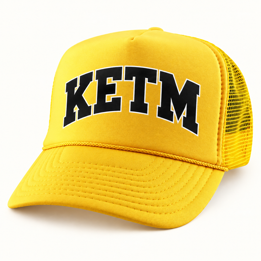 KETM foam-front trucker hat in Gold, arched DTF logo mockup