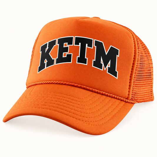KETM foam-front trucker hat in Orange, arched DTF logo mockup